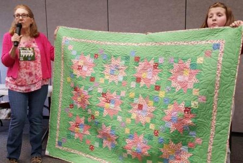 Anita is showing a set of quilts made for grandchildren that also demonstrates the effects of color choices